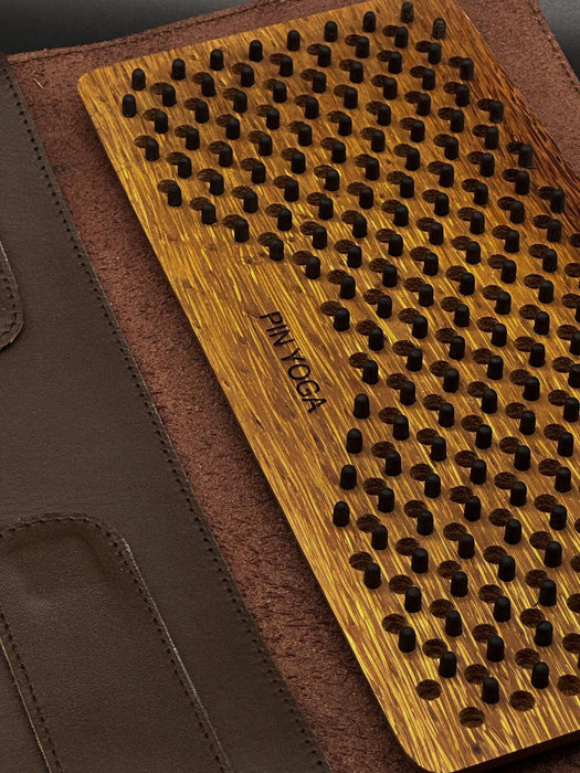 Wooden yoga mat with textured surface on a brown background