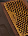 Wooden yoga mat with textured surface on a brown background