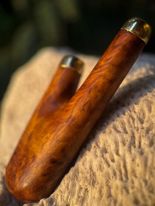 Wooden handle with gold accents on a stone surface