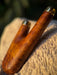 Wooden handle with gold accents on a stone surface