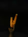 Wooden walking cane with a hand holding it against a black background