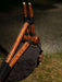 Wooden tool with black handles on a natural background