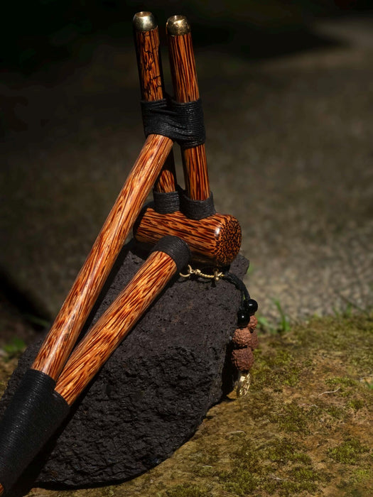 Wooden tool with black handles on a natural background