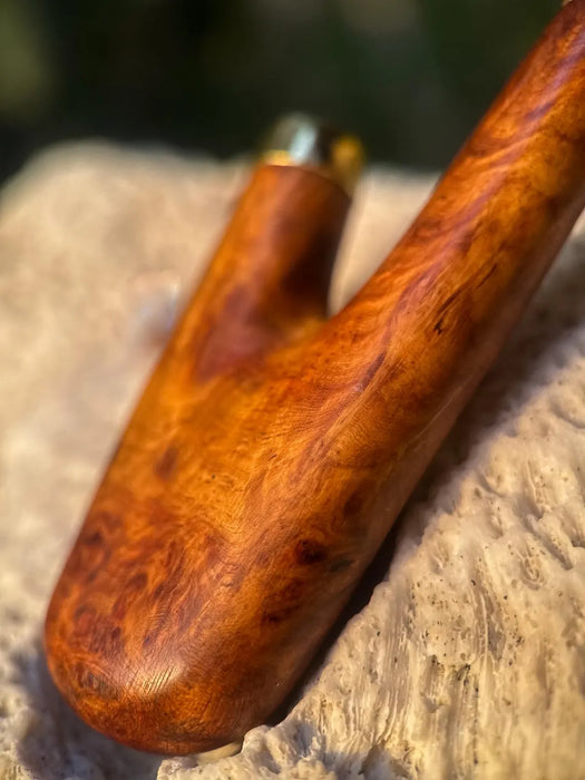 Wooden tool handle on a stone surface with a blurred background