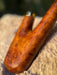 Wooden tool handle on a stone surface with a blurred background
