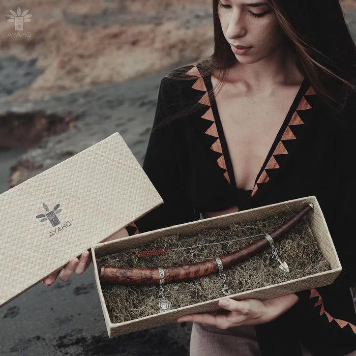 Person holding a box with a decorative item, featuring the brand 'AYAHO'.