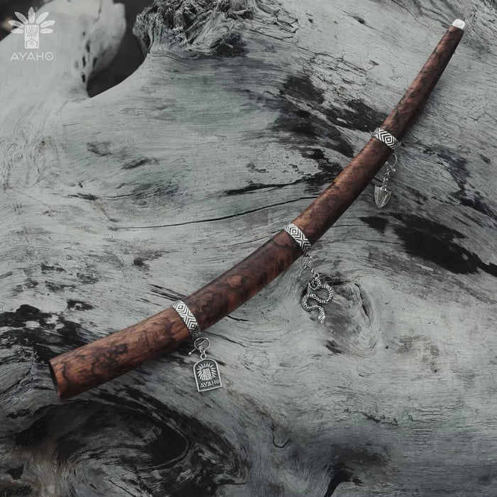 Wooden staff with decorative elements on a textured surface, featuring the AYAHO brand.