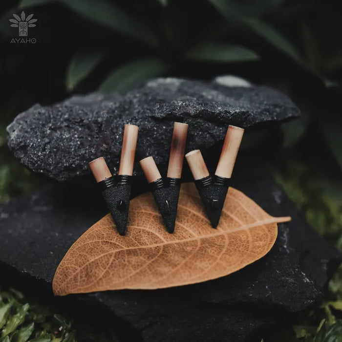 Black and wooden earrings on a leaf with Ayaho logo