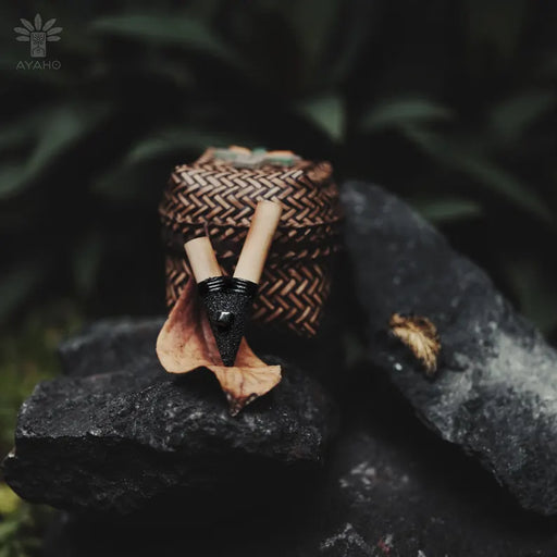Bracelet with woven design and wooden beads on a dark rock