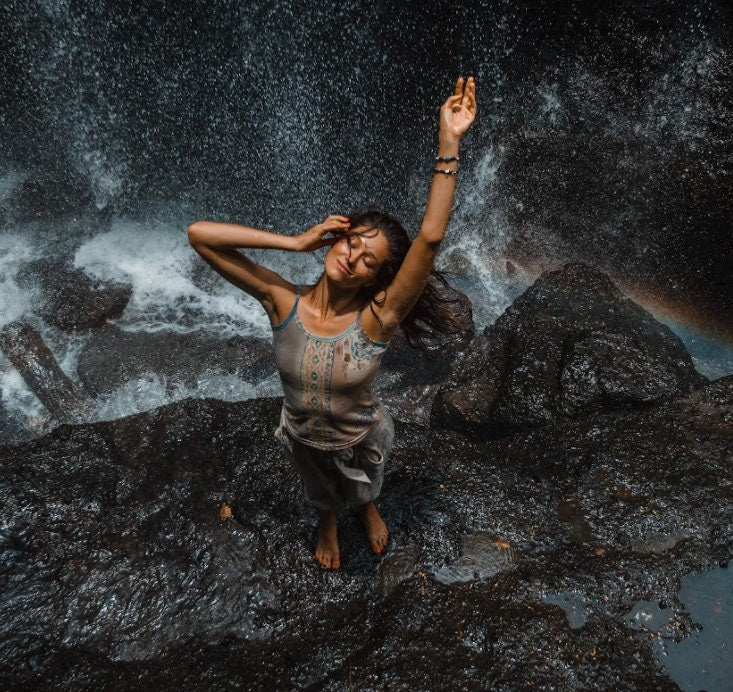 Woman wearing a relaxed-fit batik cotton shirt, inspired by shamanic and eco-conscious aesthetics