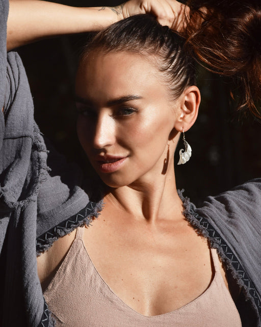 Exquisite Angel Wings earrings, crafted from lustrous mother-of-pearl and detailed sterling silver, radiating aesthetic grace and ethereal charm