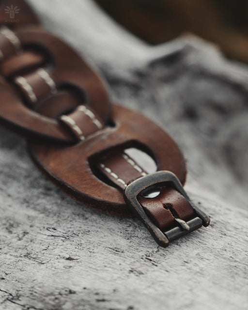 Durable buffalo hide bracelet with intertwined infinity symbols, a handcrafted statement piece for strength and balance.
