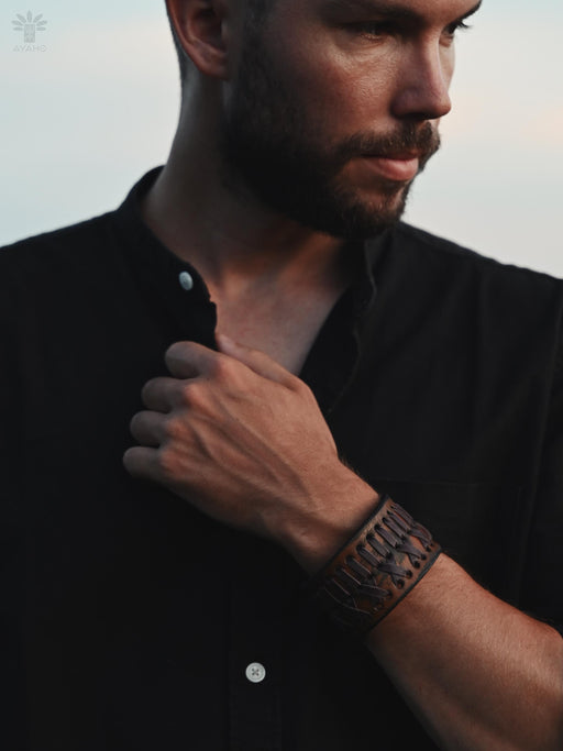 Rust-brown buffalo leather bracelet, hand-shaped and naturally dyed, with a triple-infinity loop design for grounding energy.