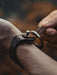Handcrafted buffalo leather bracelet with a triple-infinity motif, representing strength, power, and presence.