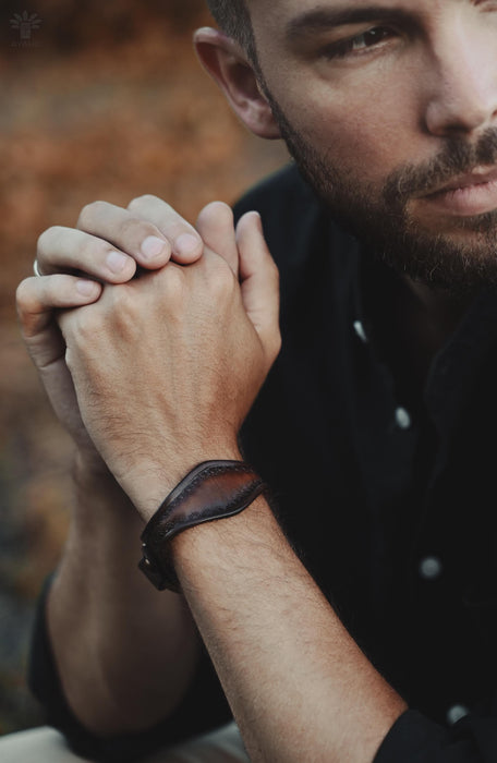Thick and natural dark buffalo leather bracelet with a hand-cut triple-infinity design, a symbol of power and rhythm.