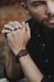 Thick and natural dark buffalo leather bracelet with a hand-cut triple-infinity design, a symbol of power and rhythm.