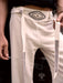 White pants with black patterns held by a person, featuring the Ayaho brand logo.