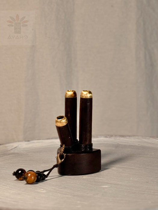 Wooden incense holder with gold accents on a neutral background