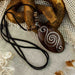 Handcrafted rosewood pendant and matching carved earrings set, embodying spiritual harmony with black kyanite and Rudraksha beads, reflecting shamanic protection