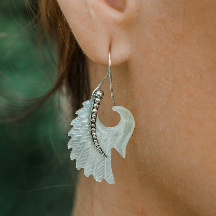 Exquisite Angel Wings  earrings, crafted from lustrous mother-of-pearl and detailed sterling silver, radiating aesthetic grace and ethereal charm