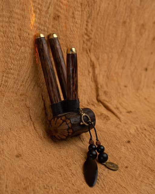 Close-up of a man using a Handmade Double Hape Kuripe, a shamanic ceremony tool for Rapé snuff application, showcasing the pipe's intricate sacred geometry and totem design for spiritual healing, meditation, and protection